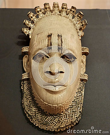 Closeup of a Benin ivory mask, featuring intricate designs and carvings Stock Photo