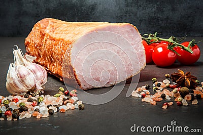 Closeup big chunk of ham gammon with spices, garlic, and tomatoes Stock Photo
