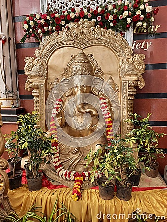 Closeup of Big Golden Color Lord Ganesha Statue at the entrance of Hindu Wedding Hall or Kalyana Mantapa during Marriage Editorial Stock Photo