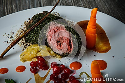 Closeup medium raw meat in dill decorated with carrot and viburnum berries Stock Photo