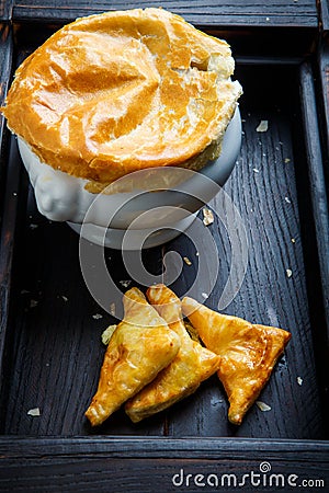 Closeup big white soup pot with bread on the top Stock Photo