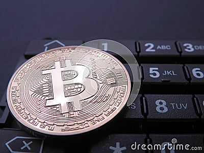 Bitcoin on top of numeric keyboard Stock Photo