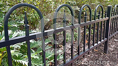 A closeup of a black fence along a path at a park in Celebration, Florida Editorial Stock Photo