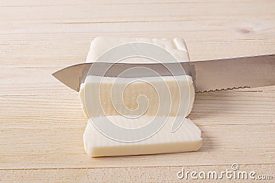 Mozzarella Cheese Being Sliced Into Servings Stock Photo