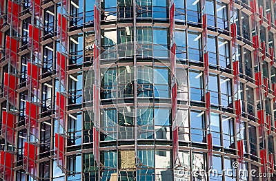 Closeup of blue windows and red walls of a business building Stock Photo