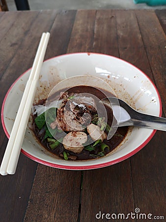 Boat noodles small noodles pork ball in bowl on wooden table Stock Photo