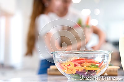 Closeup bowl, Young Asian man and woman couple together cutting slice vegetables Stock Photo