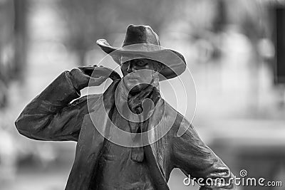 Closeup of a bronze cowboy on a blurry background Editorial Stock Photo