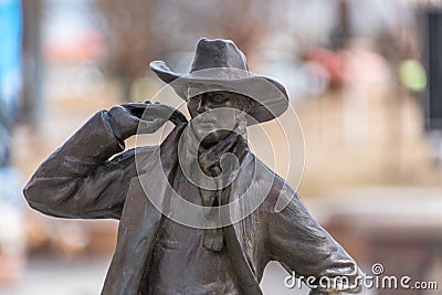 Closeup of a bronze cowboy on a blurry background Editorial Stock Photo