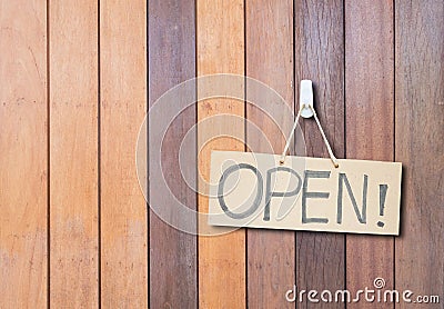 Closeup brown hard paper signboard with open massage on brown wood wall textured background with copy space Stock Photo