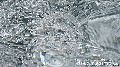 Closeup bubbling aqua texture. Cold water swirling inside glassware top view Stock Photo