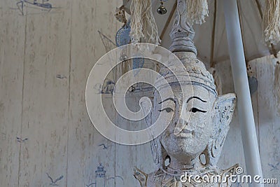 Closeup of a buddha statue under a umbrella, Buddhism a spiritual background Stock Photo