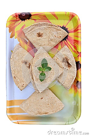 closeup the bunch brown color tortilla with green mint in the yellow white plastic tray on the white background Stock Photo