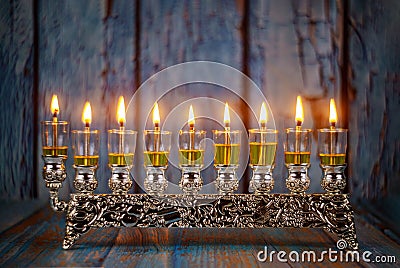 Closeup of a burning Chanukah candlestick with candles Menorah Stock Photo