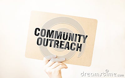 Closeup Business man hand holding show blank paper sheet mock up COMMUNITY OUTREACH Stock Photo