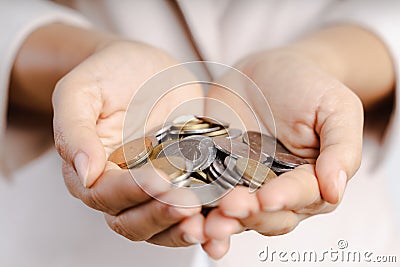 Closeup of business woman hands holding coins on white background. saving money, finacial concept Stock Photo