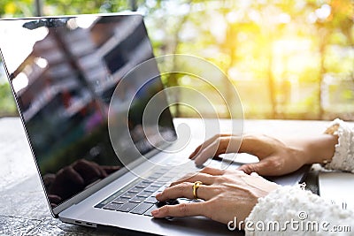 Closeup business woman hands typing on laptop keyboard on desk. Stock Photo