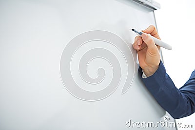 Closeup on business woman writing on flipchart Stock Photo