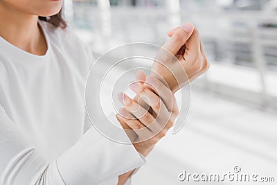 Closeup business women holding rub her wrist pain Stock Photo