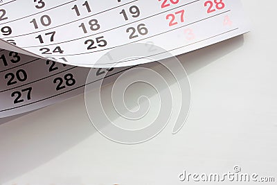 Closeup of calendar page on white office desk background. Planing work, agenda or date concept. Stock Photo
