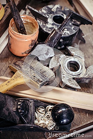 Closeup of carpentry tools in carpentry workshop. Cutter, brush, plane, shaving. Processing in vintage style. Stock Photo