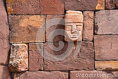 Closeup of a carved stone tenonv head embedded in wall of at the Tiwanaku UNESCO World Heritage Site near La Paz, Bolivia Editorial Stock Photo