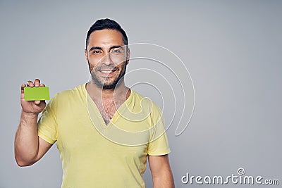 Closeup of casual hispanic man showing blank credit card Stock Photo