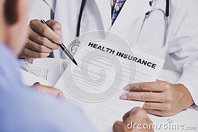 Doctor showing a health insurance policy to a man Stock Photo