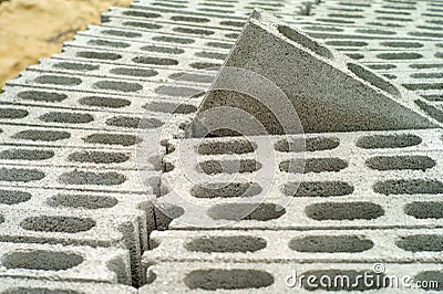 Closeup cement grey bricks out of the pile with blurred background Stock Photo