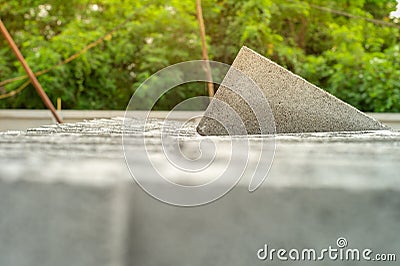 Closeup cement grey bricks out of the pile with blurred background at the construction site Stock Photo