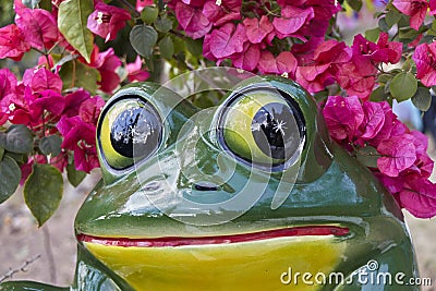 Closeup of ceramic frog with bougainvillea flowers Stock Photo