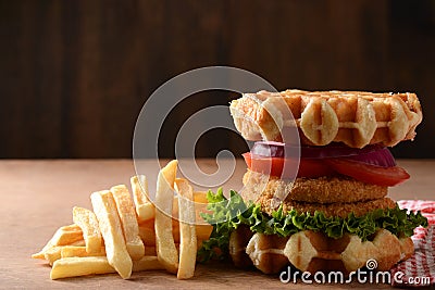 Closeup chicken burger waffle sandwich with french fries Stock Photo