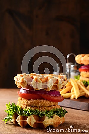 Closeup chicken burger waffle sandwich on wood table Stock Photo