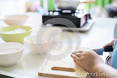 An Asian girl is learning to cook Stock Photo