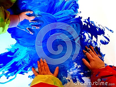 Closeup of children hands painting during a school activity - learning by doing, education and art, art therapy concept Stock Photo