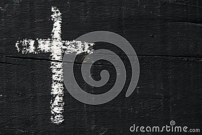 Christian cross on a dark gray wooden surface Stock Photo