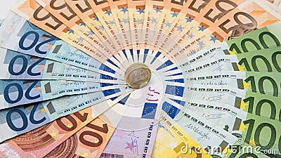 Closeup of a coin one euro with banknotes of different values. Cash money Stock Photo