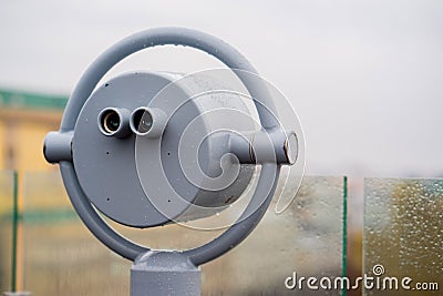 Closeup coin operated binoculars overlooking after rain Stock Photo