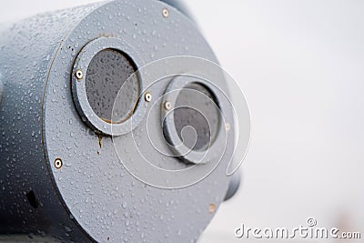 closeup coin operated binoculars overlooking after rain Stock Photo