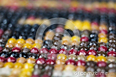 Closeup on colorful mix of round drill beads for diamond painting. Multicolored rainbow of shiny beads for background art. Macro Stock Photo