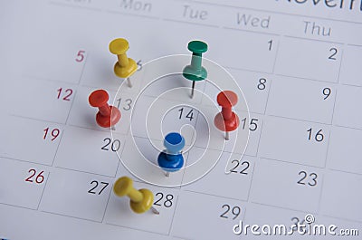 Closeup colorful pins push marking on a calendar. busy schedule Stock Photo