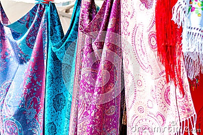 Closeup of colorful Portuguese fabrics and shawls in turquoise, pink and purple colors Stock Photo