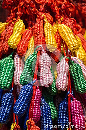 Closeup of colorful weaved peanut-shaped yarn ornaments Stock Photo