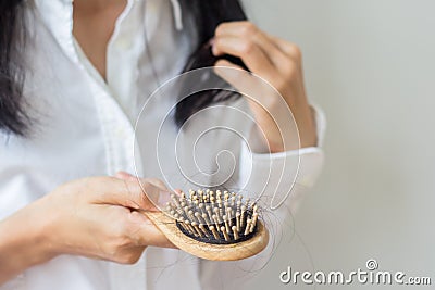 Closeup of comb brush with long loss hair .Woman loosing hair for head healthcare problem with copy space. Stock Photo