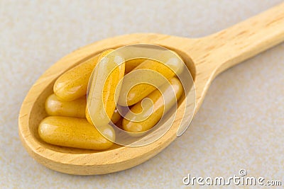 Closeup concentrated Royal Jelly in soft gel capsules in wooden Stock Photo