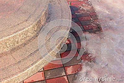 Closeup of concrete steps or terraced stairways and melting snow on a pavement Stock Photo