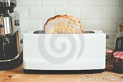 Closeup cooking bread with toaster on counter bar kitchen in morning Stock Photo