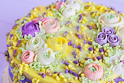 Closeup cream floral decoration on colorful cake Stock Photo