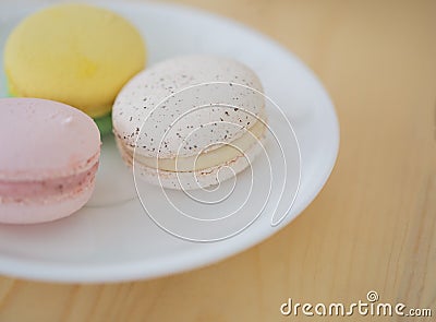 Closeup Cream macaroons , macarons on wooden background. Stock Photo