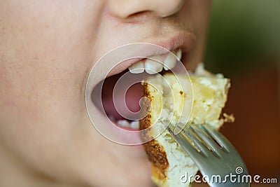 Crop anonymous young girl eating delicious potato omelette Stock Photo